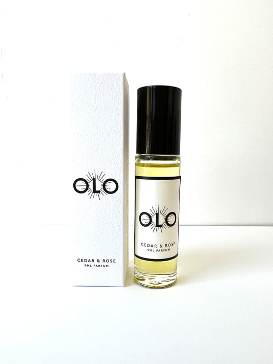 Perfume roller from OLO in a small glass bottle with a white box next to it.