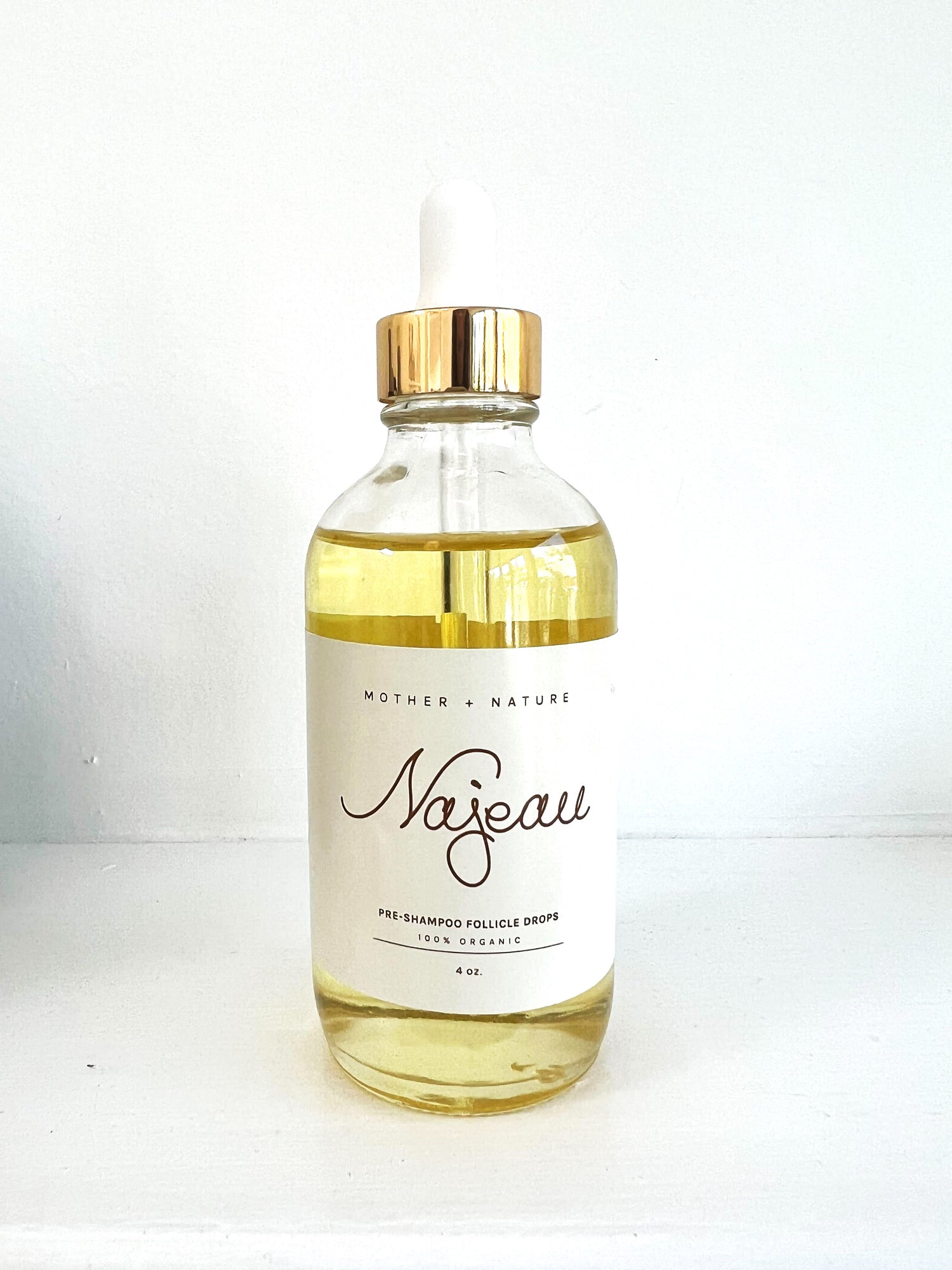 Najeau Follicle Drops in a glass container with a dropper on top, and golden liquid inside.